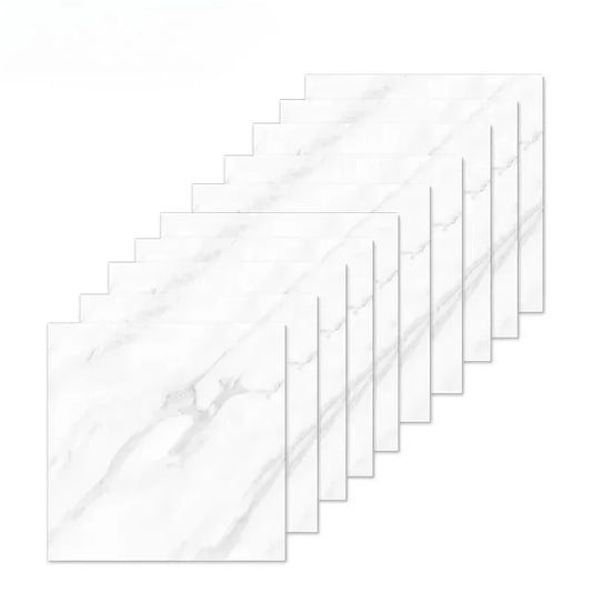 Pile of white marble effect self-adhesive tiles with grey veins on a white background