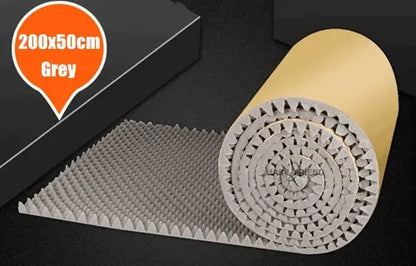 Roll of grey acoustic foam with round bumps and a kraft paper back