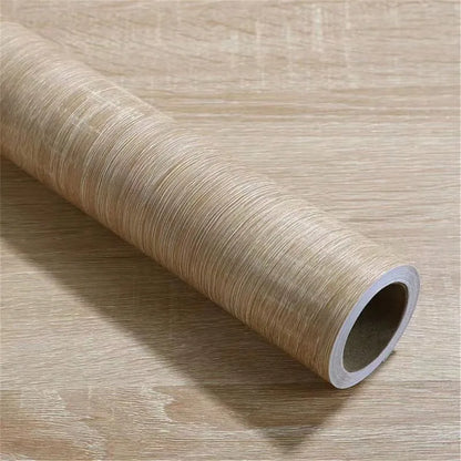 Rolle Klebefolie in heller graubeiger Holzoptik, auf flach ausgelegter Folie liegend