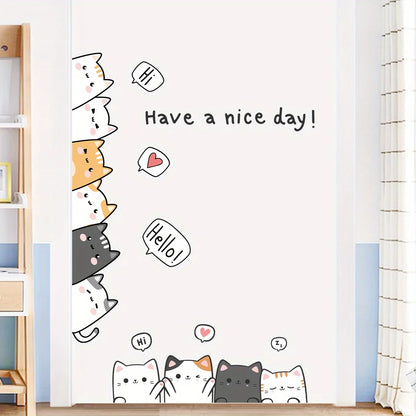White, orange and black cats stacked along the edge of a door, with the speech bubbles “Hi” and “Hello!”