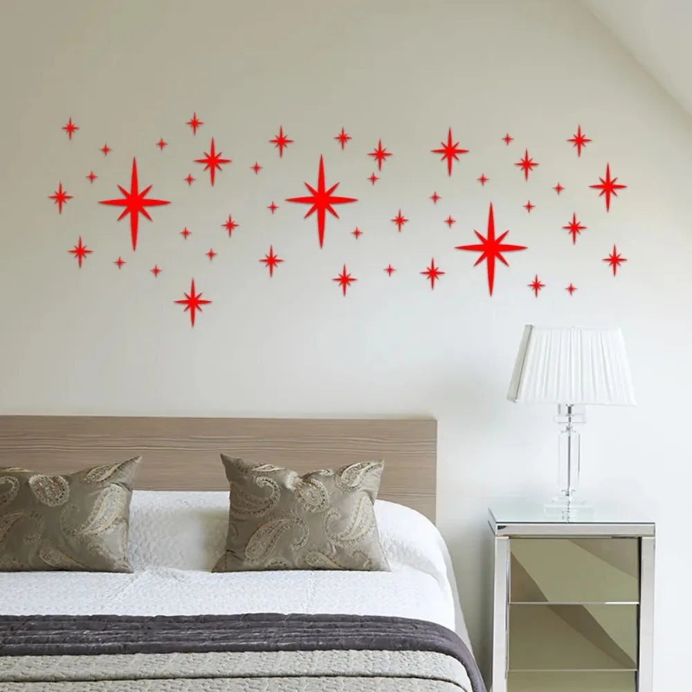 Red sparkling stars on a bed beside a lamp