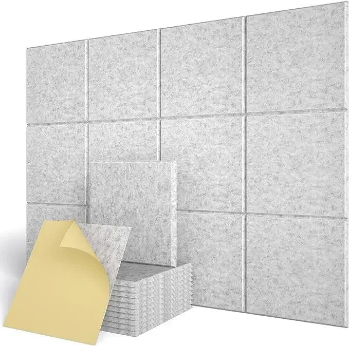 Light grey square panels fitted to a wall, with a stack of panels and the adhesive film
