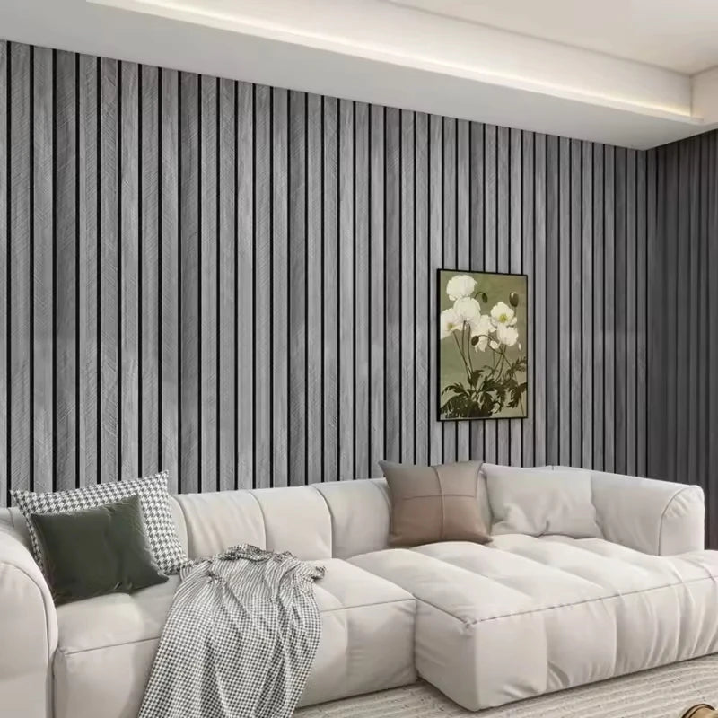 Living room with grey wood effect slatted wall behind a white sofa
