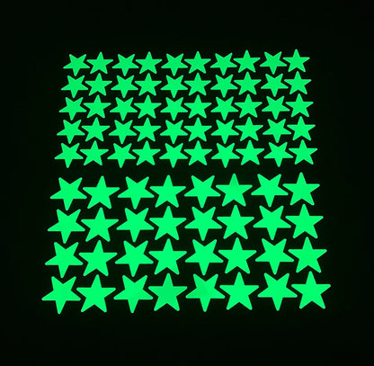 Glow in the dark stars of two sizes arranged in a grid on a black background