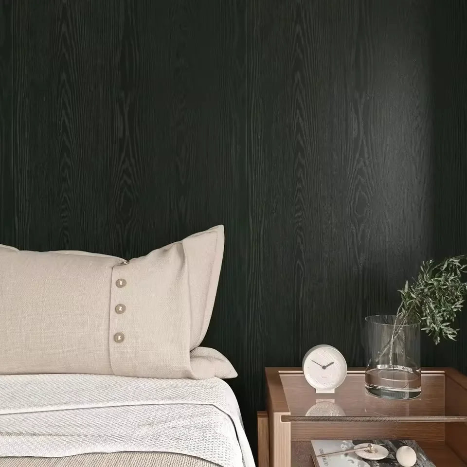 Bedroom wall covered in black wood effect adhesive vinyl