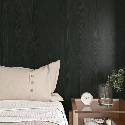 Bedroom wall covered in black wood effect adhesive vinyl