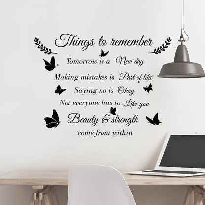 Quote sticker with butterflies on a desk with a laptop and a pendant lamp