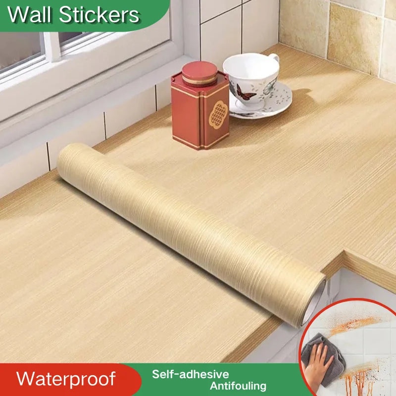 Roll of light wood effect self-adhesive vinyl resting on a worktop