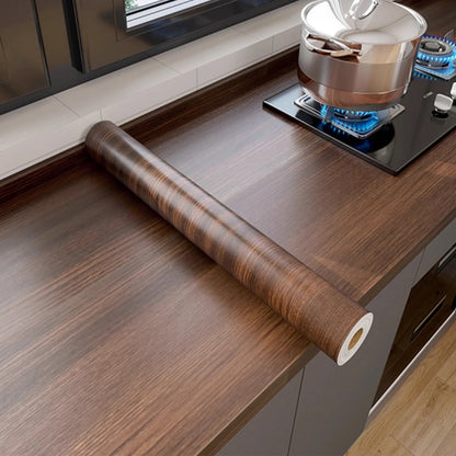 Roll of dark walnut effect self-adhesive vinyl on a kitchen worktop