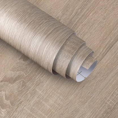 Geöffnete Rolle Folie in Eichenoptik in Grau-Taupe mit weißer, rasterbedruckter Rückseite