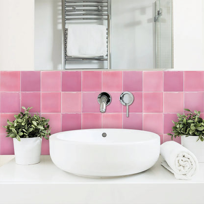 White washbasin with a strip of pink gradient tile stickers on the bathroom wall