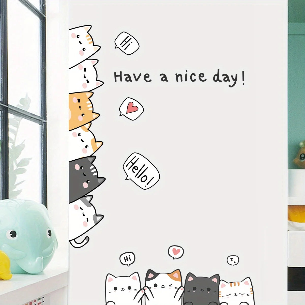 Close-up of cartoon cats with speech bubbles and “Have a nice day!” applied to a white wall
