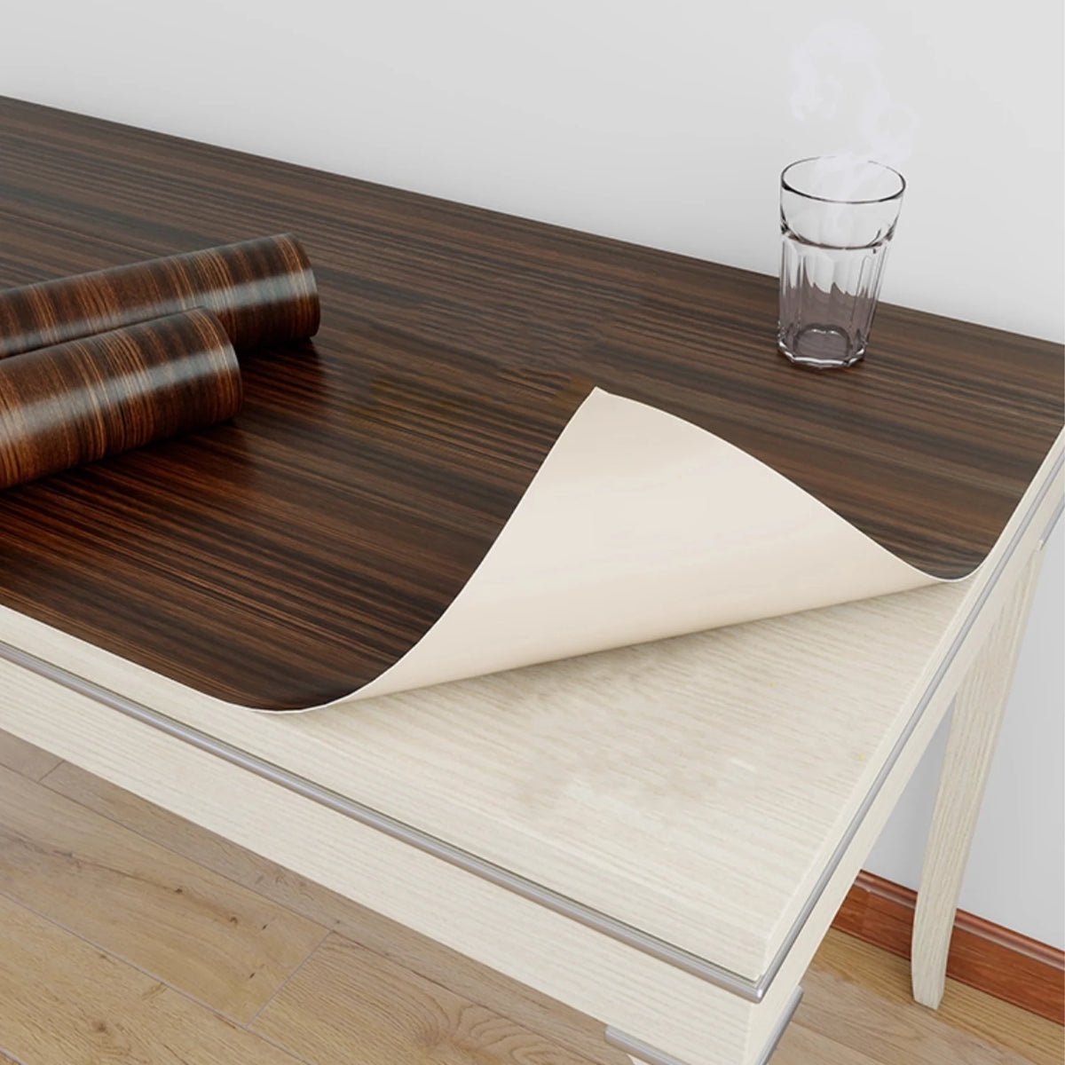 Dark walnut effect self-adhesive vinyl on a table, with the light back visible