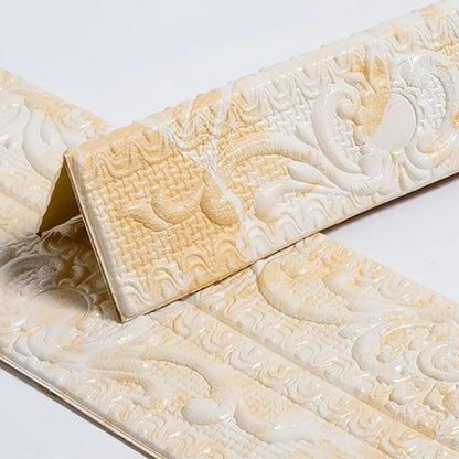 Yellow and white self-adhesive moulding with raised decoration, folded in a V