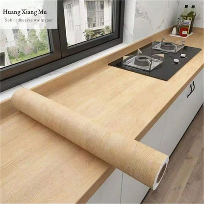 Roll of blonde wood effect vinyl wrap on a kitchen worktop, Model 6